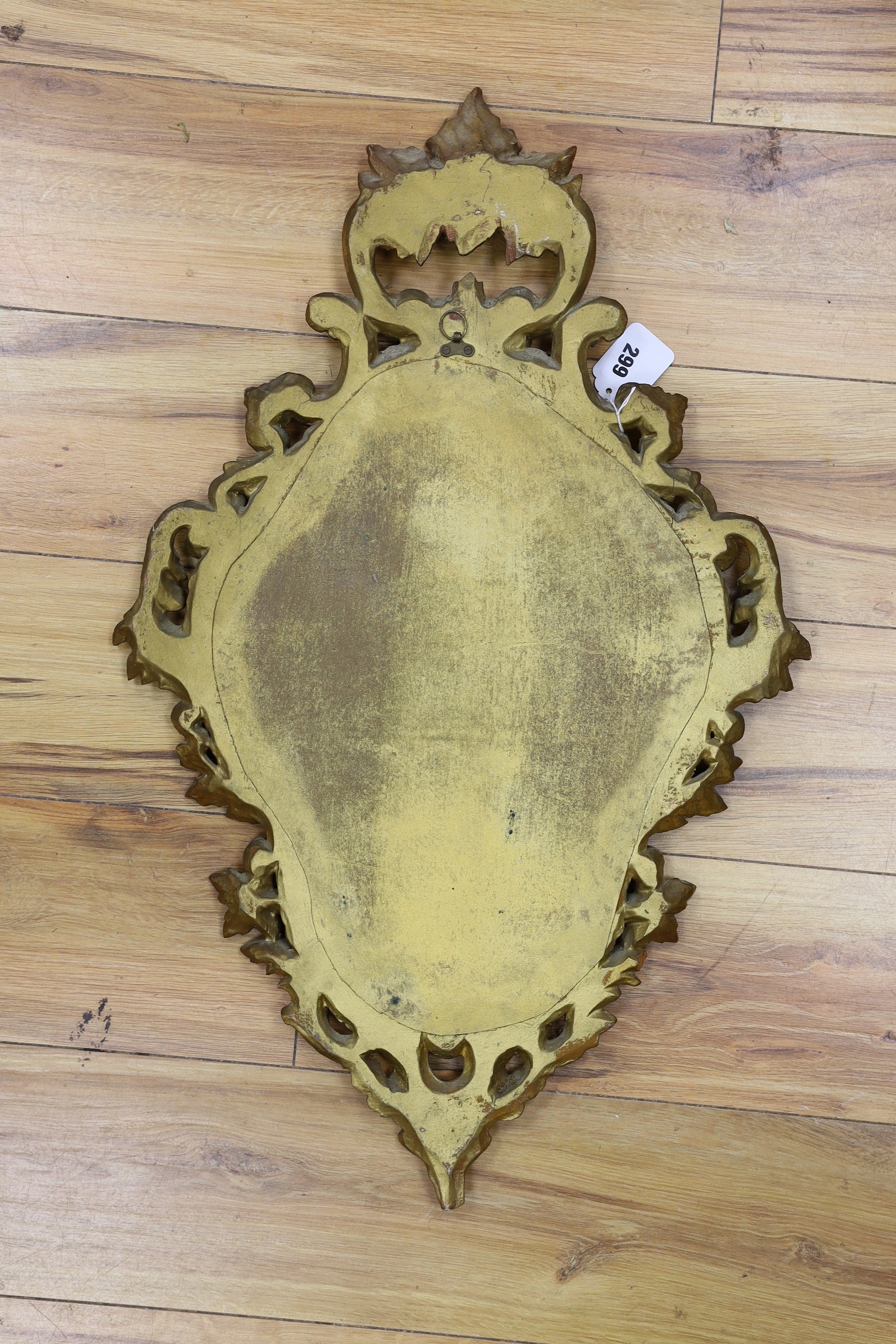 A reproduction gilt framed wall mirror, in the Rococo style, 73cm tall